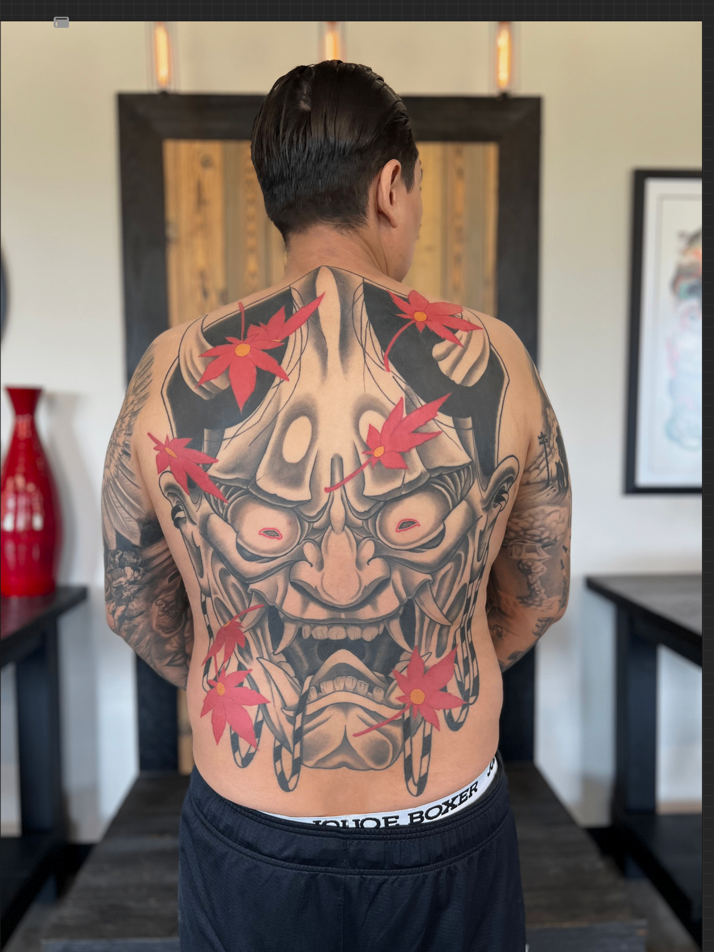 Back tattoo portfolio piece with red leaves