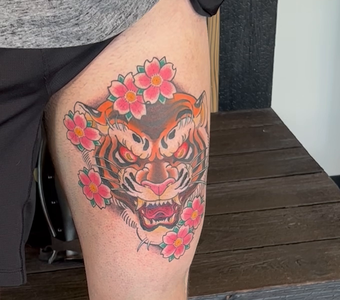 Japanese tiger and cherry blossom thigh tattoo by Curt Travis