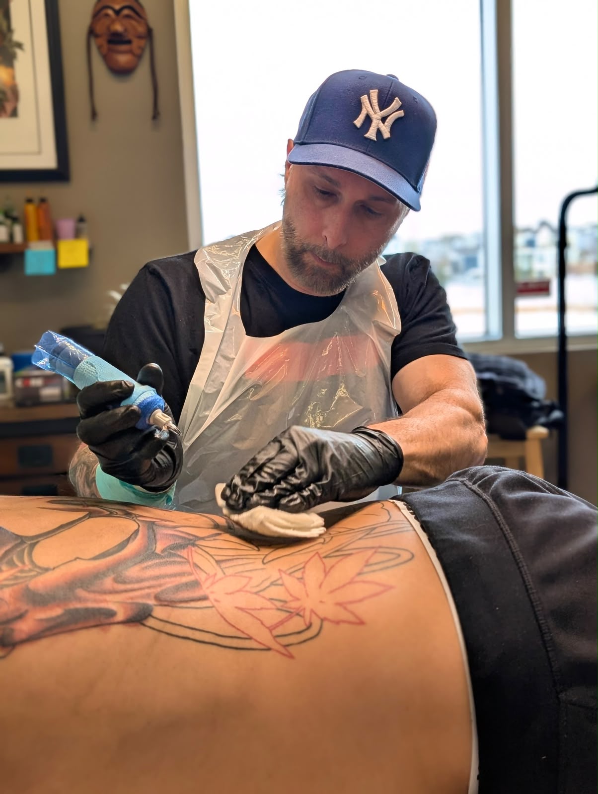 Curt Travis tattooing a client in his Edmonton studio